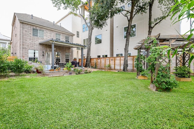 7608 Janak Dr, Houston, TX 77055 - back of property featuring brick siding, a vegetable garden, and a patio area