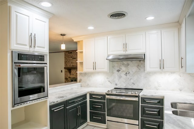 215 Edward Ln, Brenham, TX 77833 - kitchen with appliances with stainless steel finishes, under cabinet range hood, white cabinets, open shelves, and recessed lighting