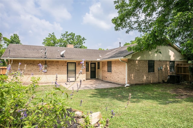 215 Edward Ln, Brenham, TX 77833 - back of house with a chimney, brick siding, a patio, and central AC