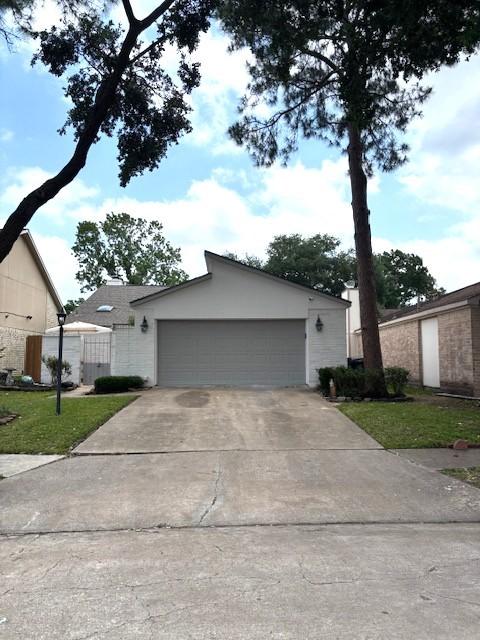 3407 S Briar Knoll Dr, Houston, TX 77082 - mid-century inspired home with a garage and a front lawn