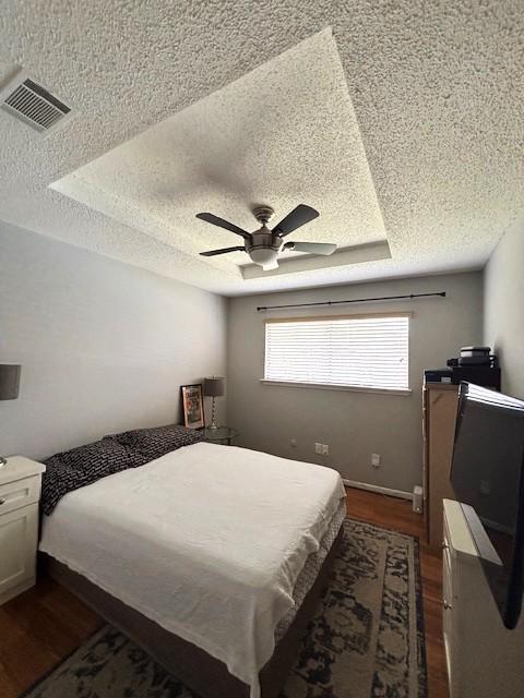 3407 S Briar Knoll Dr, Houston, TX 77082 - bedroom with a textured ceiling, dark wood-style flooring, and ceiling fan