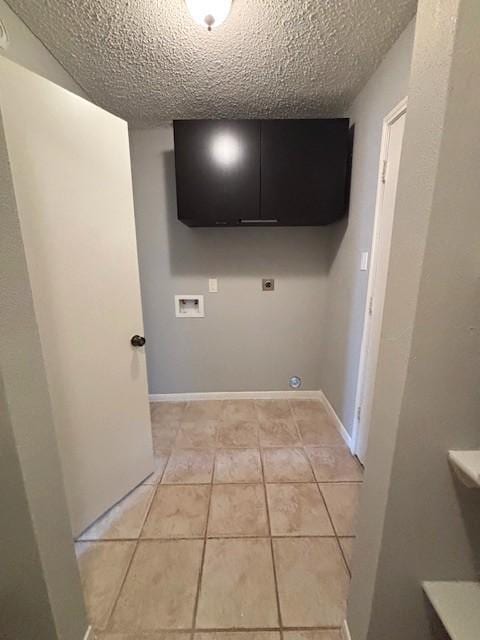 3407 S Briar Knoll Dr, Houston, TX 77082 - laundry room with electric dryer hookup, washer hookup, a textured ceiling, and light tile patterned flooring