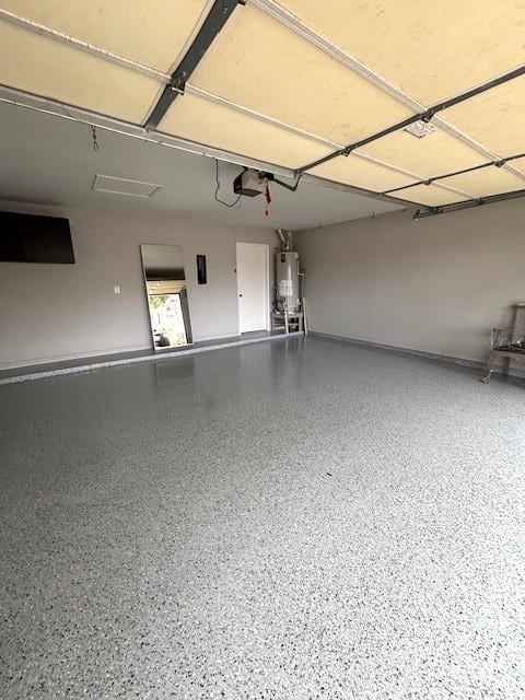 3407 S Briar Knoll Dr, Houston, TX 77082 - garage with gas water heater, a garage door opener, and electric panel