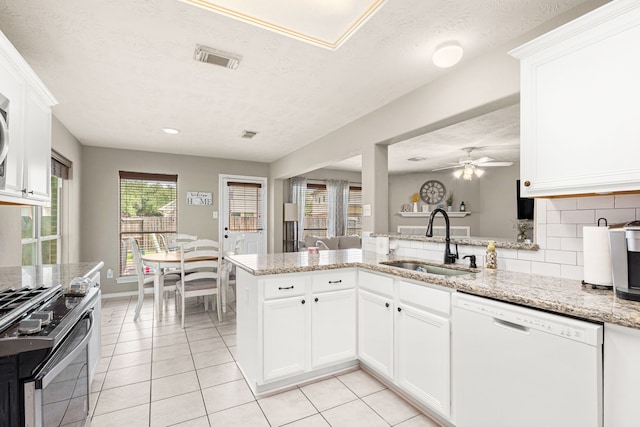 13617 Jasmine Creek Ln, Rosharon, TX 77583 - kitchen with dishwasher, a sink, range with gas cooktop, light tile patterned floors, and ceiling fan