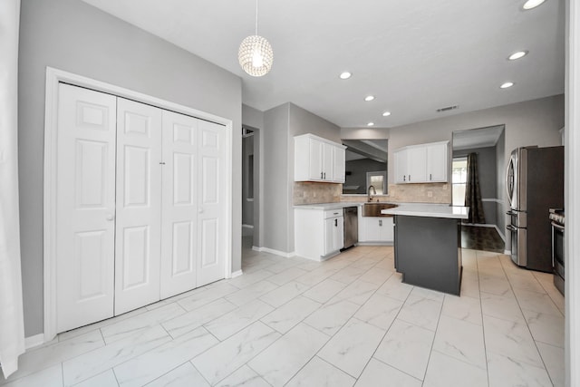 11027 Collingswood Dr, La Porte, TX 77571 - kitchen with appliances with stainless steel finishes, light marble finish flooring, recessed lighting, white cabinets, and a sink