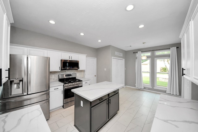 11027 Collingswood Dr, La Porte, TX 77571 - kitchen featuring appliances with stainless steel finishes, light marble finish floors, white cabinetry, and recessed lighting