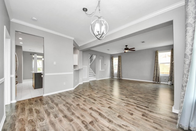 11027 Collingswood Dr, La Porte, TX 77571 - unfurnished living room with a chandelier, stairs, wood finished floors, ceiling fan, and ornamental molding