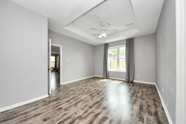 11027 Collingswood Dr, La Porte, TX 77571 - spare room featuring a raised ceiling, a ceiling fan, wood finished floors, and baseboards