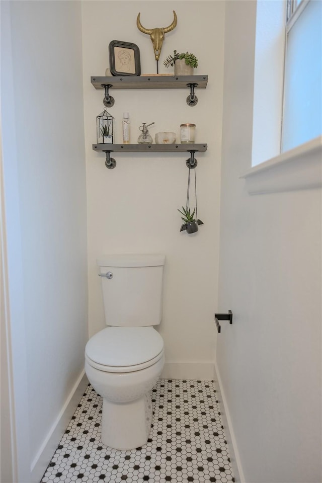 13215 Ravensway Dr, Cypress, TX 77429 - bathroom featuring baseboards, toilet, and tile patterned flooring