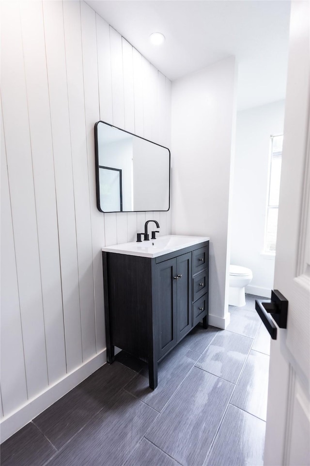 13215 Ravensway Dr, Cypress, TX 77429 - bathroom featuring toilet, vanity, wood tiled floors, and baseboards