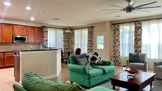 4438 W Maple Dr, Friendswood, TX 77546 - living area with light tile patterned floors, plenty of natural light, ceiling fan, and recessed lighting
