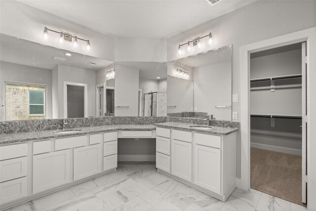 231 Upland Dr, Waller, TX 77484 - bathroom with marble finish floors, a stall shower, a walk in closet, and vanity
