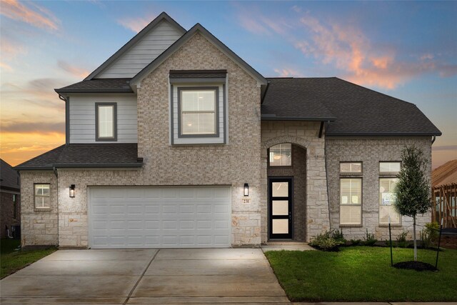 231 Upland Dr, Waller, TX 77484 - view of front of house with stone siding, a shingled roof, an attached garage, concrete driveway, and a front lawn