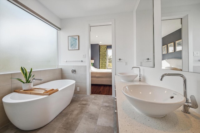 4812 Chenevert St Unit A, Houston, TX 77004 - full bath featuring ensuite bathroom, tile walls, a freestanding tub, and double vanity