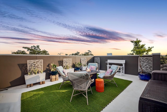 4812 Chenevert St Unit A, Houston, TX 77004 - patio terrace at dusk featuring a yard, a patio, and an outdoor living space with a fire pit