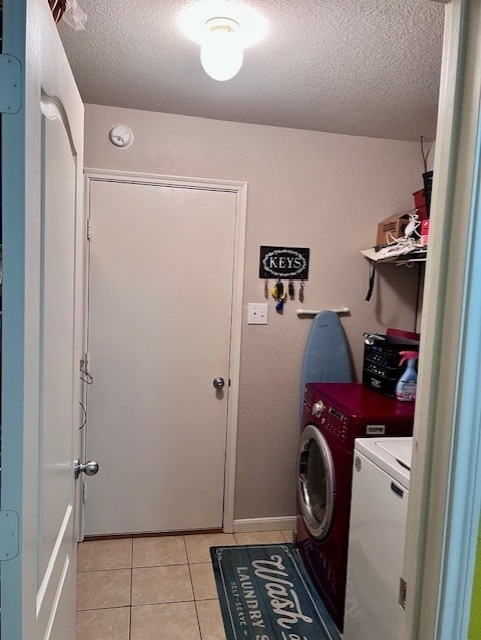 7907 Owl Ln, Baytown, TX 77523 - washroom featuring washer and dryer, a textured ceiling, and light tile patterned flooring