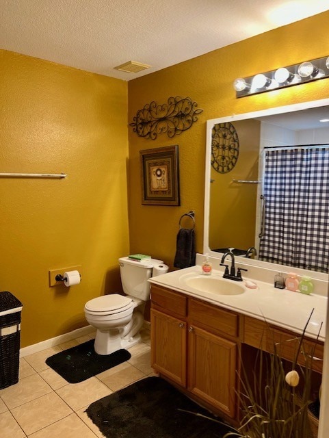 7907 Owl Ln, Baytown, TX 77523 - full bathroom featuring tile patterned flooring, toilet, vanity, a shower with curtain, and a textured wall
