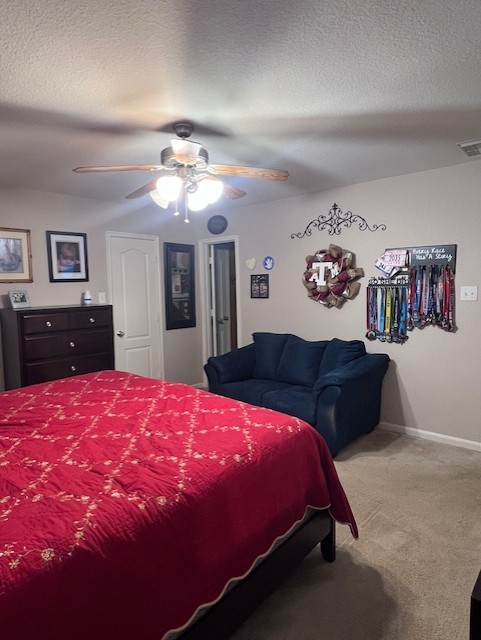 7907 Owl Ln, Baytown, TX 77523 - carpeted bedroom with a ceiling fan, baseboards, and a textured ceiling