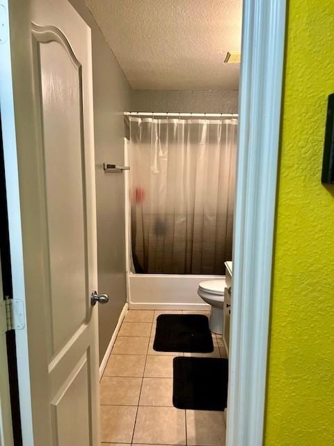 7907 Owl Ln, Baytown, TX 77523 - bathroom with a textured wall, tile patterned flooring, a textured ceiling, toilet, and shower / bathtub combination with curtain