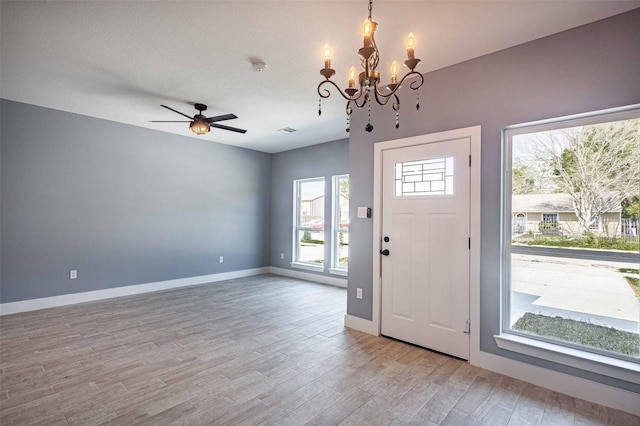 5714 Pershing St A/B, Unit A/B Houston, TX 77033 - entrance foyer featuring a chandelier, light wood-type flooring, baseboards, and a ceiling fan