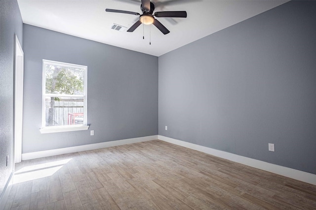 5714 Pershing St A/B, Unit A/B Houston, TX 77033 - spare room featuring wood finished floors, a ceiling fan, and baseboards