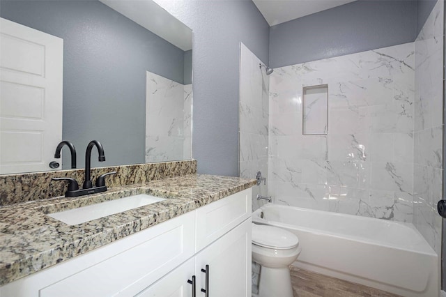 5714 Pershing St A/B, Unit A/B Houston, TX 77033 - bathroom featuring toilet, shower / tub combination, vanity, wood finished floors, and a textured wall