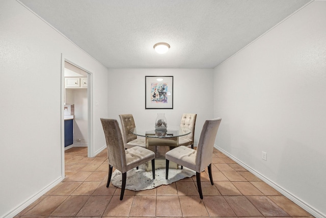 17116 Beaver Springs Dr Unit 7, Houston, TX 77090 - dining area with a textured ceiling, light tile patterned floors, and baseboards