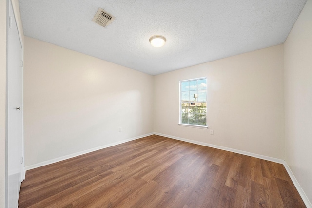 17116 Beaver Springs Dr Unit 7, Houston, TX 77090 - empty room with wood finished floors, baseboards, and a textured ceiling