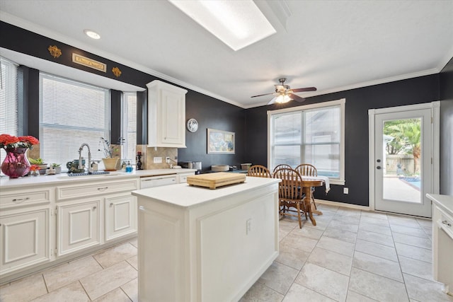 2326 Pin Hook Ct, Seabrook, TX 77586 - kitchen with a sink, light countertops, a kitchen island, crown molding, and light tile patterned flooring