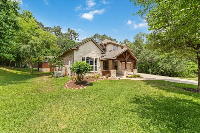 2260 Teas Crossing Dr, Conroe, TX 77304 - view of front of house featuring stone siding, driveway, and a front yard