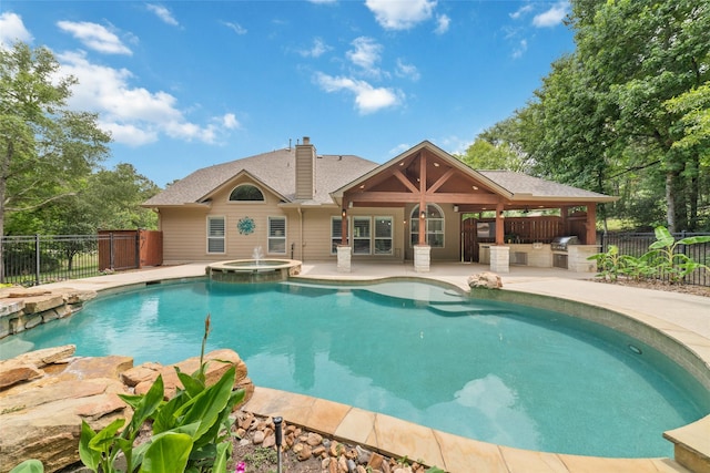 2260 Teas Crossing Dr, Conroe, TX 77304 - view of swimming pool with a patio area, a pool with connected hot tub, and an outdoor bar