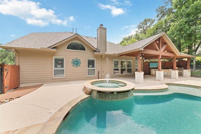 2260 Teas Crossing Dr, Conroe, TX 77304 - view of pool with a patio, a pool with connected hot tub, and an outdoor kitchen