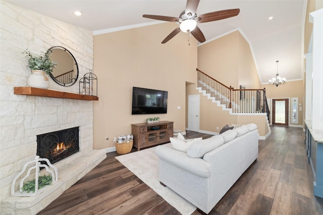 2260 Teas Crossing Dr, Conroe, TX 77304 - living room featuring stairs, dark wood-style floors, a fireplace, a towering ceiling, and a ceiling fan