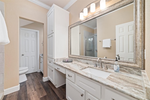 2260 Teas Crossing Dr, Conroe, TX 77304 - bathroom featuring ornamental molding, a shower stall, vanity, wood finished floors, and toilet