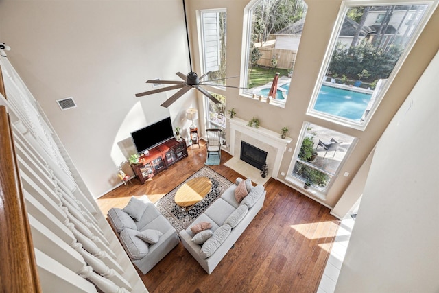 3919 Park Circle Way, Houston, TX 77059 - living room with a towering ceiling, a fireplace with flush hearth, wood finished floors, and ceiling fan