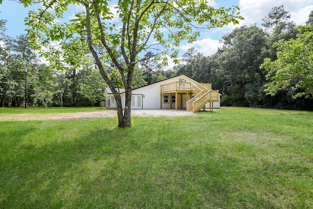 527 Fm 787th Rd E, Cleveland, TX 77327 - view of green lawn with stairway and a wooden deck