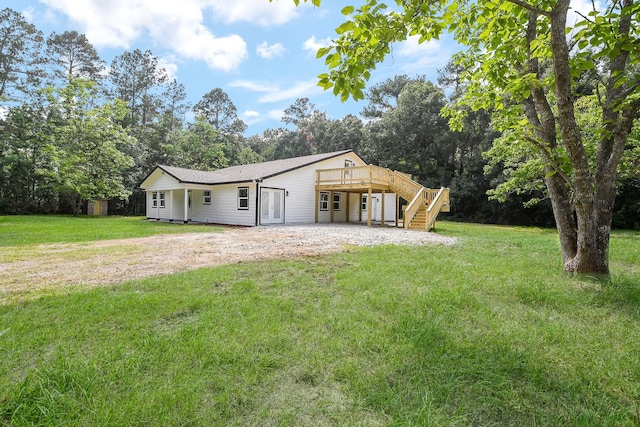 527 Fm 787th Rd E, Cleveland, TX 77327 - back of property with a wooden deck, stairs, a lawn, a patio, and french doors