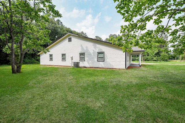 527 Fm 787th Rd E, Cleveland, TX 77327 - back of property with a yard and central air condition unit