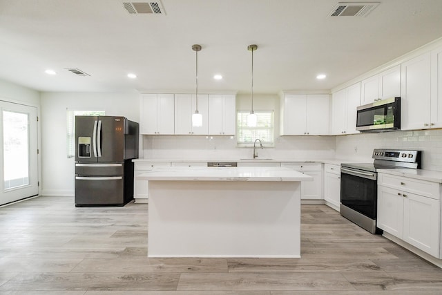 527 Fm 787th Rd E, Cleveland, TX 77327 - kitchen featuring appliances with stainless steel finishes, a sink, a center island, decorative backsplash, and recessed lighting