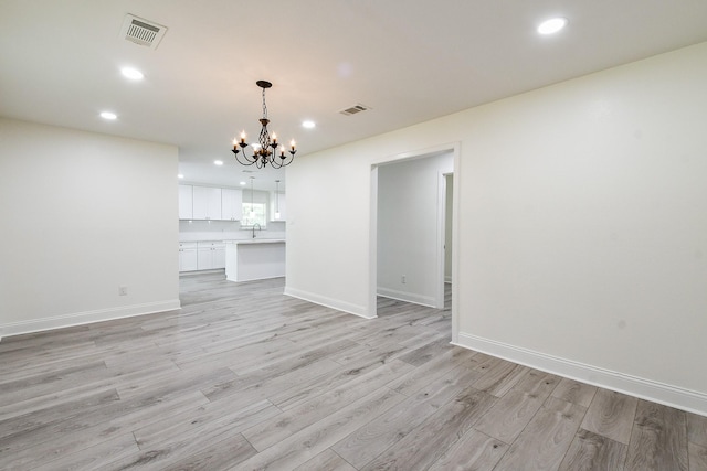 527 Fm 787th Rd E, Cleveland, TX 77327 - unfurnished dining area with a chandelier, recessed lighting, light wood finished floors, a sink, and baseboards