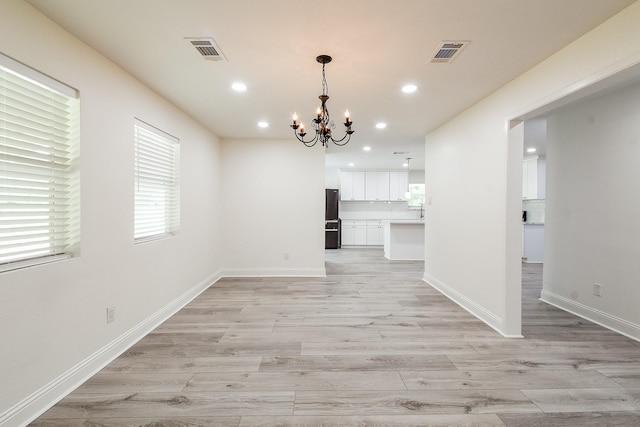 527 Fm 787th Rd E, Cleveland, TX 77327 - unfurnished dining area with a chandelier, light wood-style flooring, healthy amount of natural light, and recessed lighting