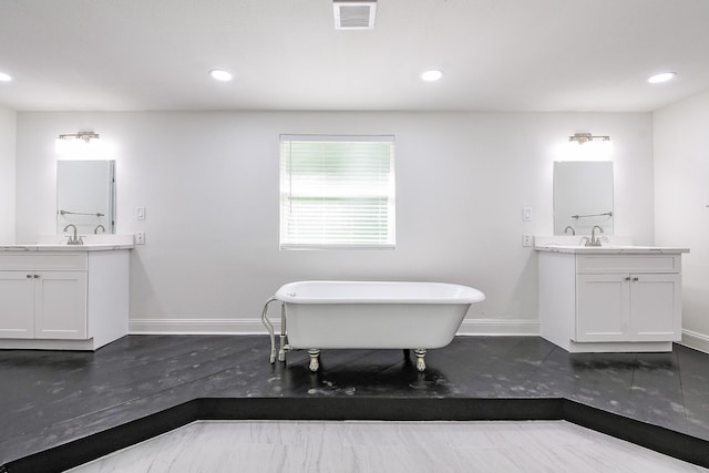 527 Fm 787th Rd E, Cleveland, TX 77327 - bathroom featuring baseboards, a soaking tub, two vanities, recessed lighting, and wood finished floors