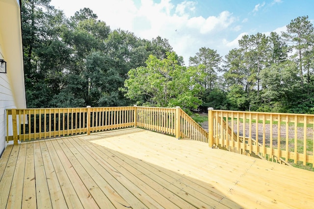 527 Fm 787th Rd E, Cleveland, TX 77327 - wooden terrace with view of wooded area