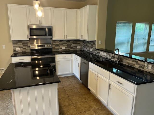 16127 Port O Call St, Crosby, TX 77532 - kitchen featuring appliances with stainless steel finishes, a sink, tasteful backsplash, and dark countertops