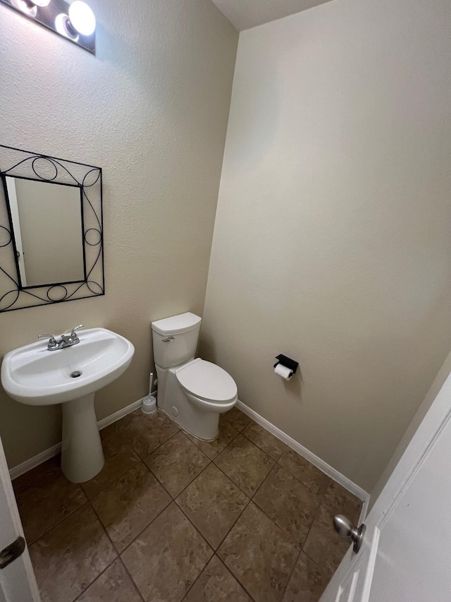 16127 Port O Call St, Crosby, TX 77532 - half bathroom featuring toilet, tile patterned flooring, and baseboards