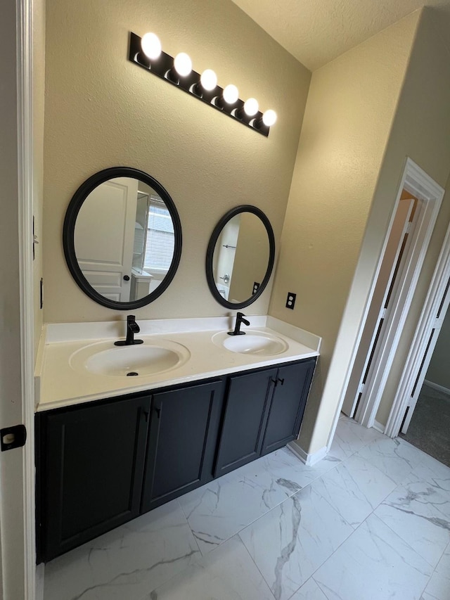 16127 Port O Call St, Crosby, TX 77532 - bathroom with double vanity, marble finish floors, and baseboards