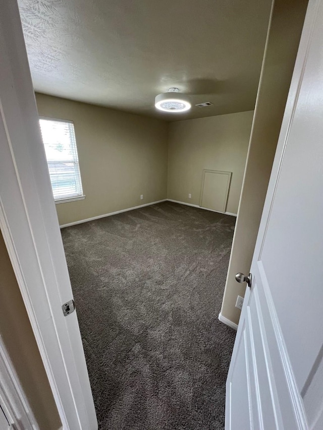 16127 Port O Call St, Crosby, TX 77532 - spare room featuring dark carpet and baseboards
