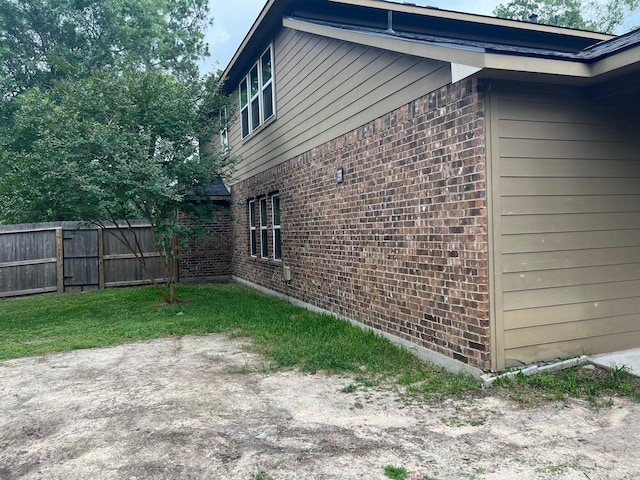 16127 Port O Call St, Crosby, TX 77532 - view of property exterior featuring brick siding and a patio