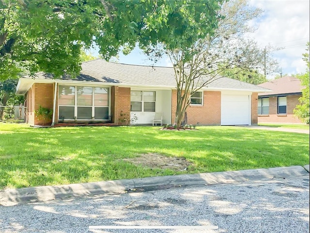 717 Grantham Rd, Baytown, TX 77521 - single story home with brick siding, a garage, and a front lawn