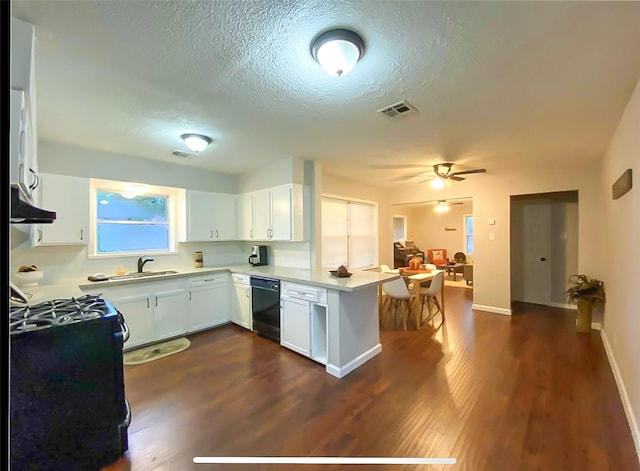 717 Grantham Rd, Baytown, TX 77521 - kitchen with dishwasher, a peninsula, gas range, a ceiling fan, and dark wood finished floors
